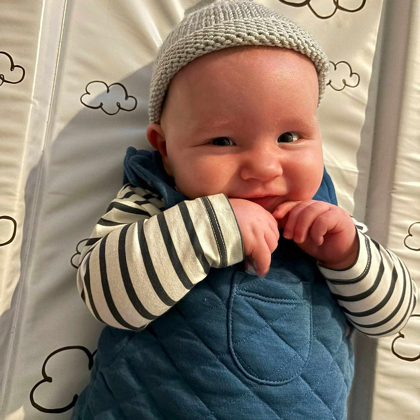 Innes is registered to the contest to win money with this photo: baby, blanket, bodypart, bonnet, cap, clothing, coat, face, finger, hand, happy, hat, head, jacket, newborn, pants, person, photography, portrait, smile