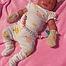 Arianna is registered to the contest to win money with this photo: baby, infant, blanket, pink, mittens, headband, pacifier, pacifier_clip, sleeping, clothing, pajamas, cute, soft, lying_down, bedroom, child, person, indoor, resting, adorable