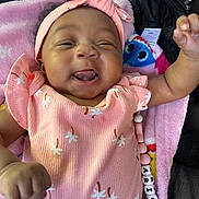 Arianna joined the competition — help win amazing prizes! adorable, baby, blanket, child, closeup, cute, happy, headband, indoors, infant, joyful, lying_down, patterned_clothing, person, pink_clothing, playful, portrait, smiling, soft_texture, tongue_out