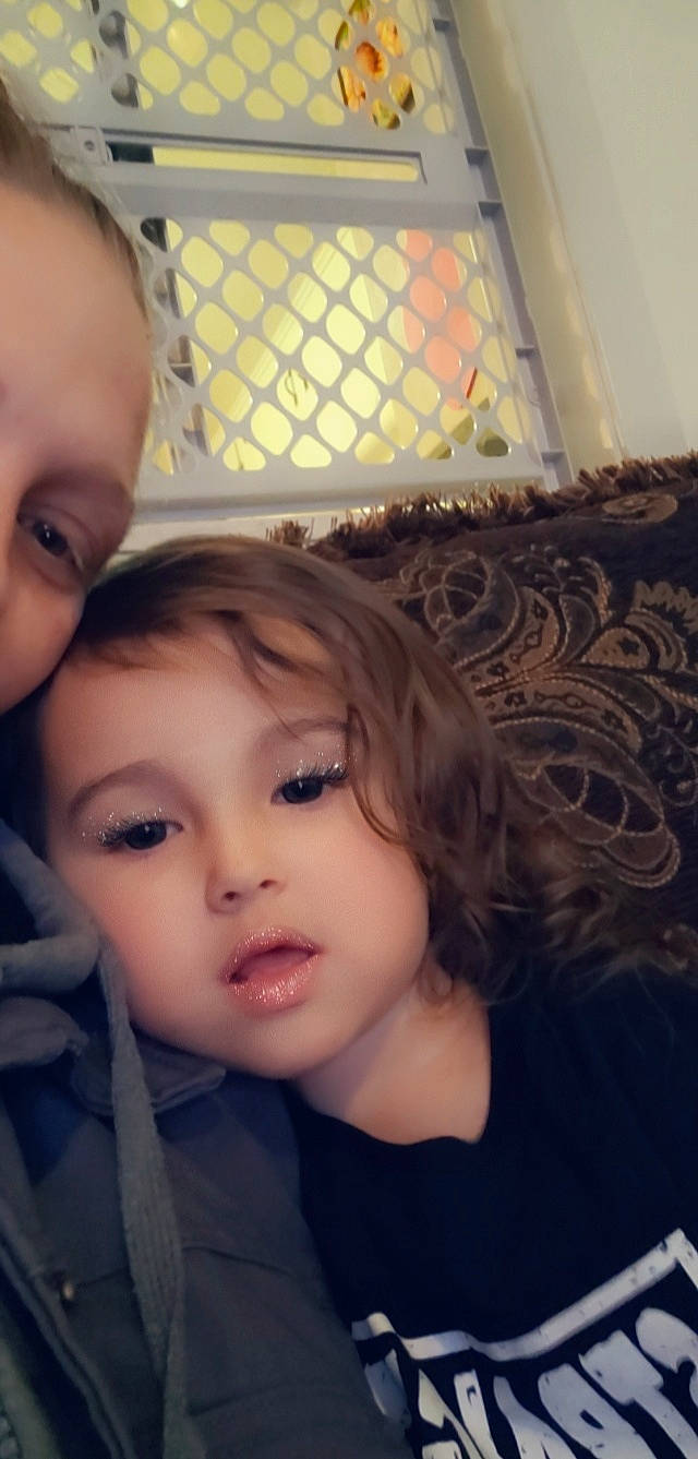 Riley joined the competition — help win amazing prizes! bangs, brown_hair, cheek, child, ear, eyelash, fun, gesture, hair_coloring, happy, iris, lamp, lip, long_hair, nose, person, selfie, sitting, skin, toddler