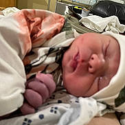 Oaklynn is registered to the contest to win money with this photo: newborn, baby, infant, sleeping, closeup, hospital, blanket, hat, swaddle, tiny_hand, wrinkled_skin, bed, towel, tray_table, foot, face, mouth, nose, portrait, soft_lighting