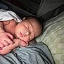 baby, newborn, sleeping, asleep, infant, portrait, close_up, hand, arm, blanket, bedding, pillow, crib, skin, lips, head, cozy, indoor, peaceful, family