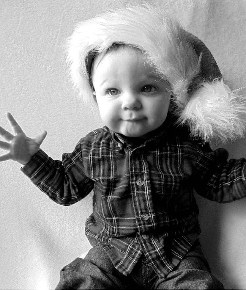 Giovanni is registered to the contest to win money with this photo: arm, black, black_and_white, clothing, eye, facial_expression, finger, gesture, hand, happy, head, iris, person, photograph, skin, sleeve, standing, style, tartan, toddler
