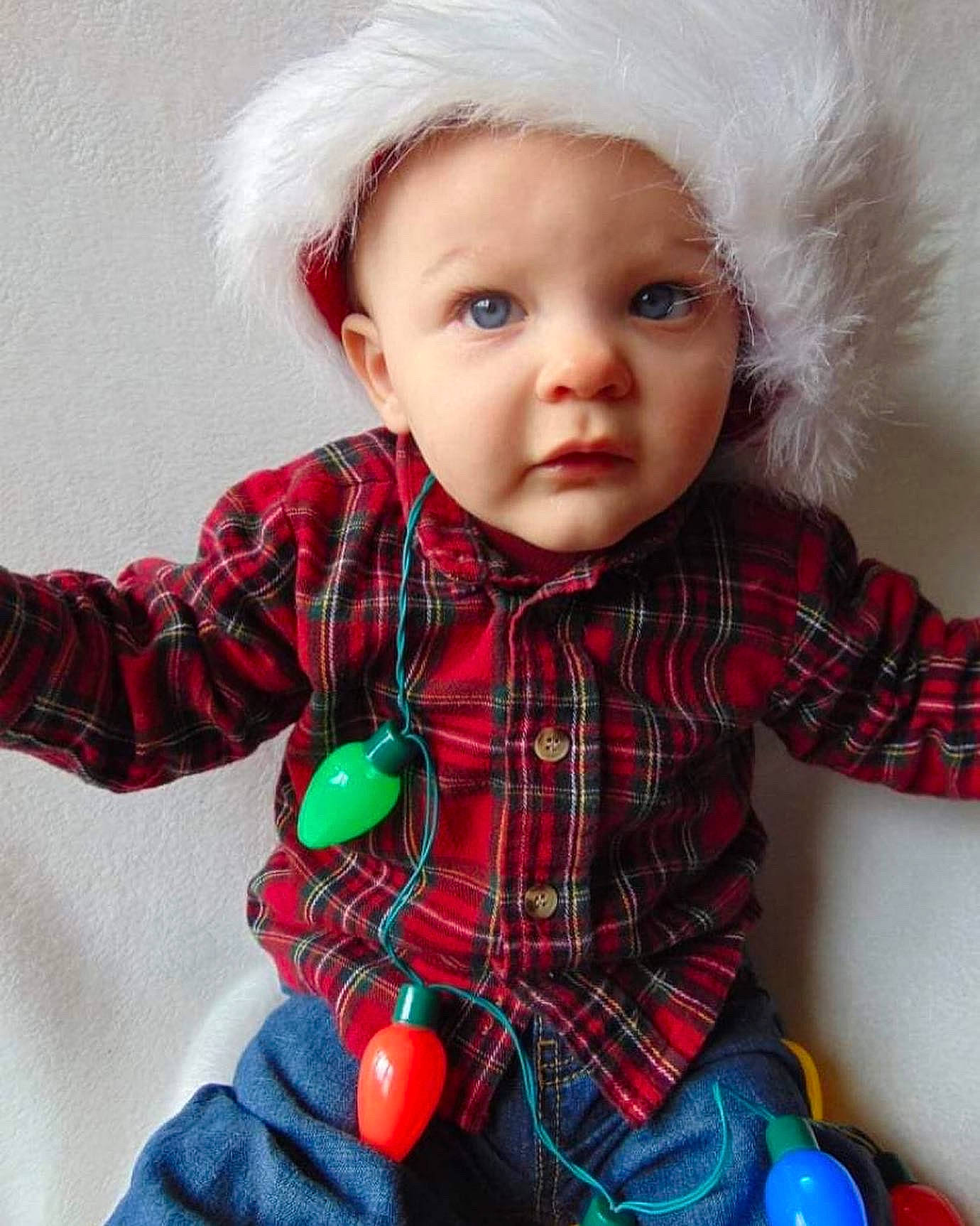 Giovanni is registered to the contest to win money with this photo: baby, baby_toddler_clothing, child, eye, facial_expression, hat, headwear, iris, organ, outerwear, pattern, person, plaid, product, red, sleeve, standing, tartan, textile, toddler