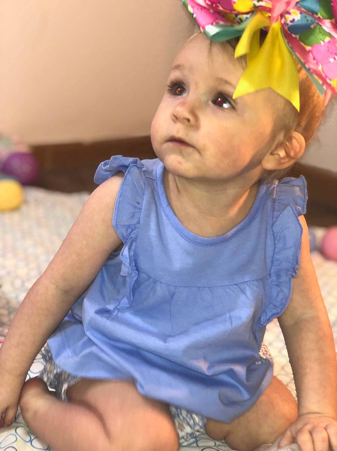 Nova is registered to the contest to win money with this photo: baby, baby_toddler_clothing, cheek, child, dress, eye, face, facial_expression, fun, happy, head, headwear, iris, neck, orange, party_hat, person, pink, purple, skin