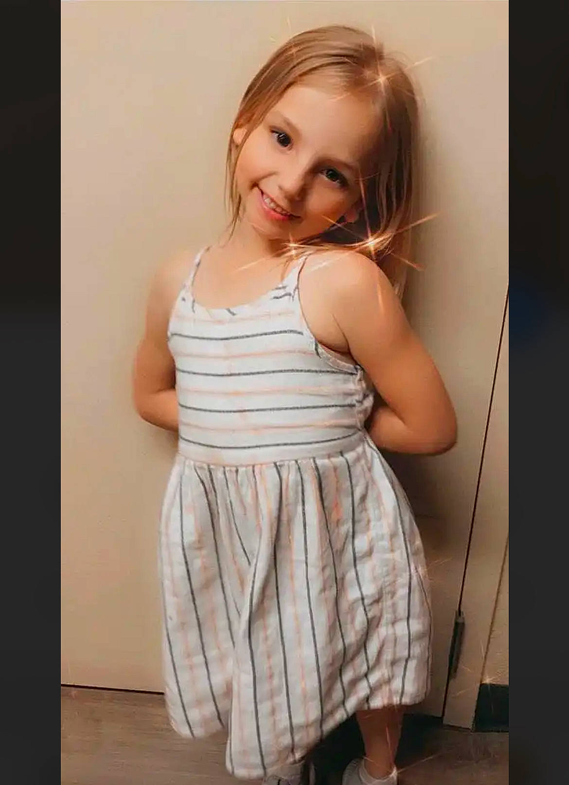 Sophia is registered to the contest to win money with this photo: arm, baby_toddler_clothing, day_dress, elbow, face, fashion_design, flash_photography, gesture, hair, happy, head, joy, long_hair, neck, one_piece_garment, person, shoulder, sleeve, sleeveless_shirt, smile