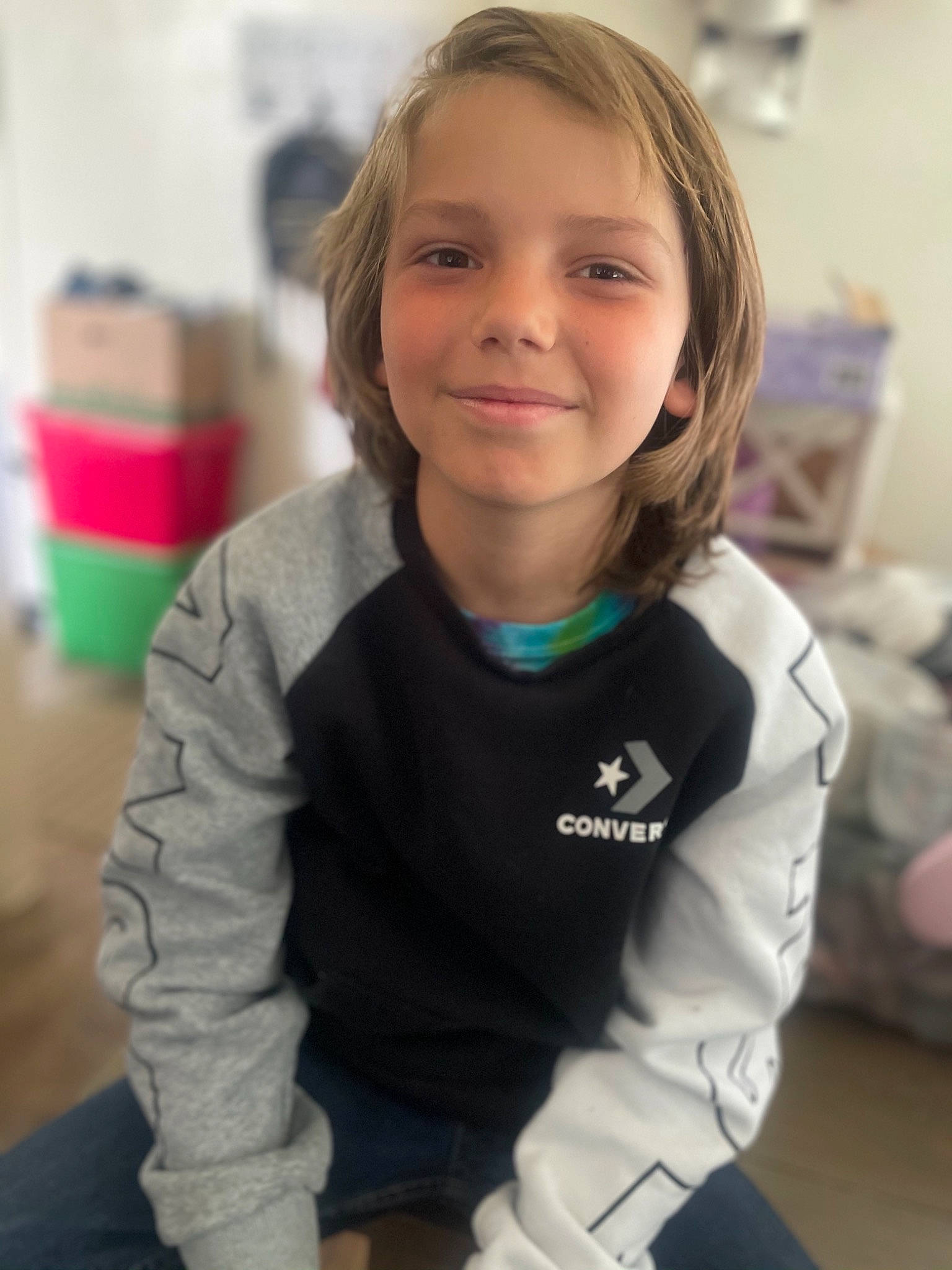 Prince is registered to the contest to win money with this photo: arm, blond, cheek, child, electric_blue, face, fun, hair, happy, head, hood, jacket, joy, long_sleeved_t_shirt, neck, person, room, sitting, sleeve, smile