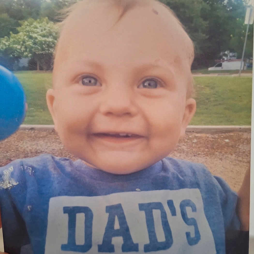 Emerson joined the competition — help win amazing prizes! baby, child, smiling, blue_shirt, outdoor, park, grass, trees, ball, happy, face, person, head, cute, young_child, nature, daylight, toddler, casual_clothing, portrait