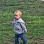 toddler, child, boy, hoodie, blue_jeans, brown_shoes, grass, outdoor, nature, field, walking, young_child, casual_clothing, daylight, person, greenery, small_plant, cute, explorer, determined