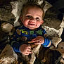 baby, child, smiling, blanket, pajamas, cozy, indoor, cute, happy, face, hands, soft, warm, car_print, football_print, infant, portrait, comfortable, bedroom, toddler