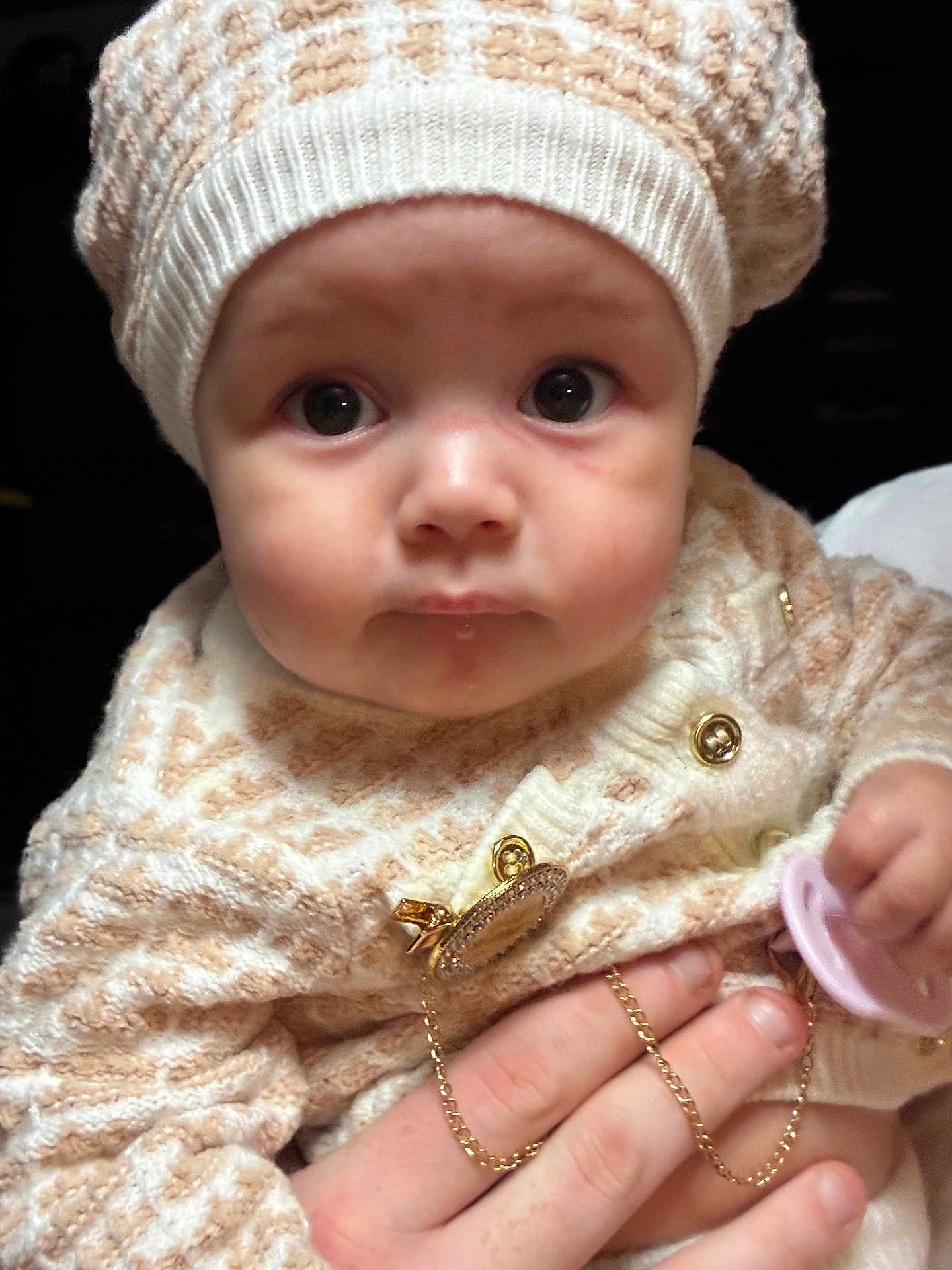 Dallas joined the competition — help win amazing prizes! baby, infant, face, hat, knitwear, sweater, pacifier, hand, child, closeup, portrait, cute, warm_clothing, gold_chain, expression, skin, eyes, indoor, person, young_child