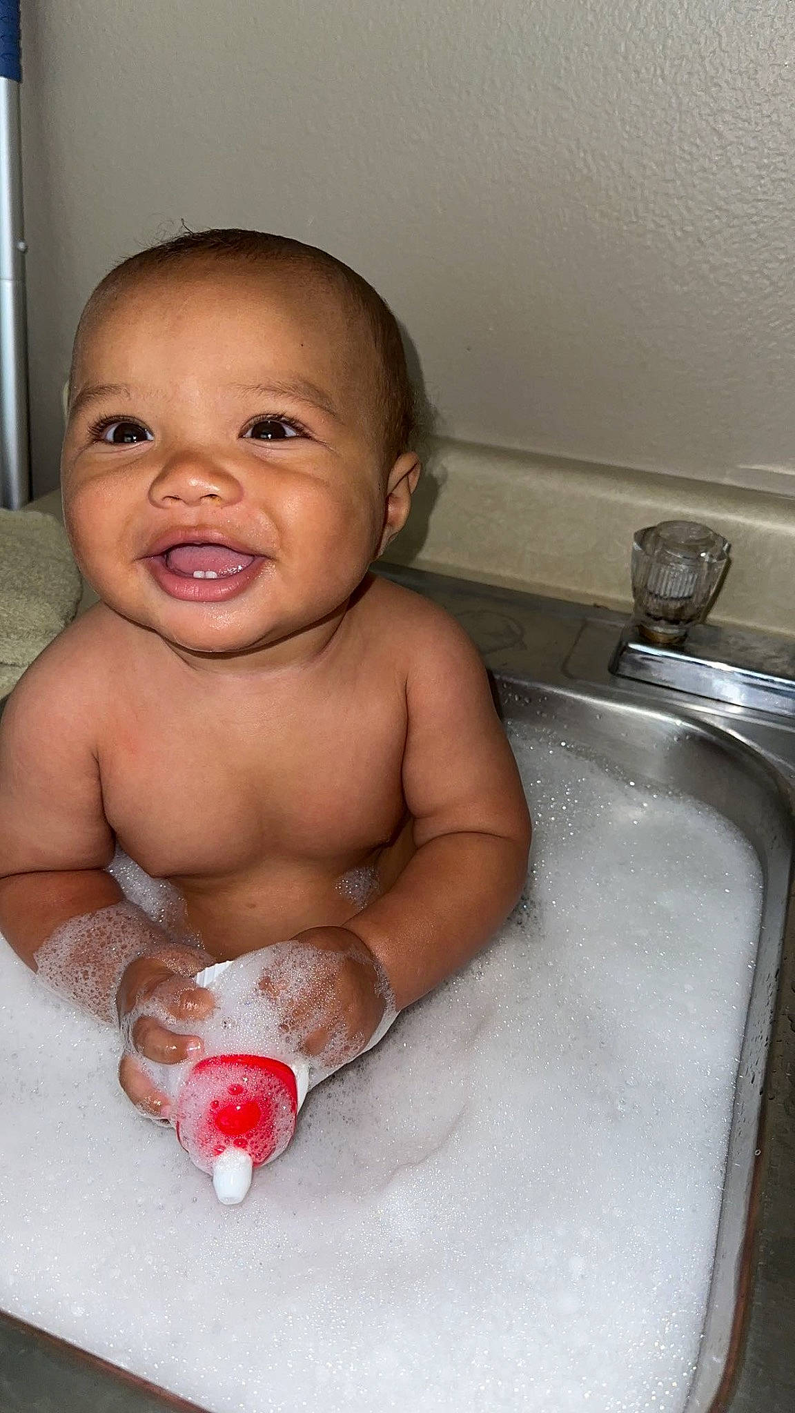 Kenai joined the competition — help win amazing prizes! baby, baby_bathing, bathing, bathroom, bathtub, cheek, chest, eye, finger, fluid, fun, mouth, person, plumbing, plumbing_fixture, sink, skin, smile, tap, toddler