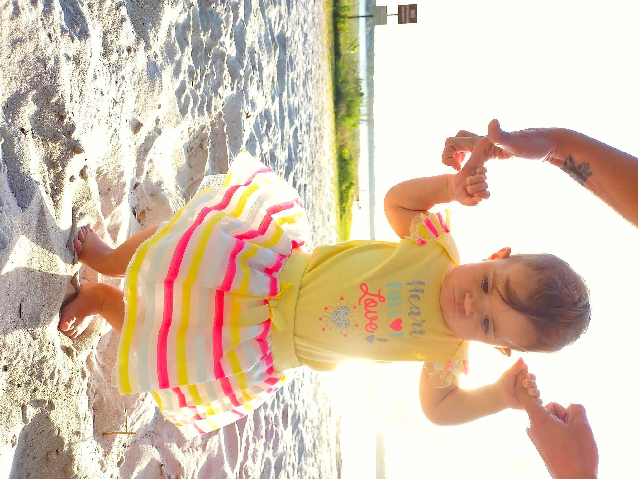Naomi is registered to the contest to win money with this photo: arm, beach, child, elbow, finger, fun, hand, happy, human_leg, leisure, light, people_in_nature, person, red, sky, summer, swimwear, thigh, toddler, trunk