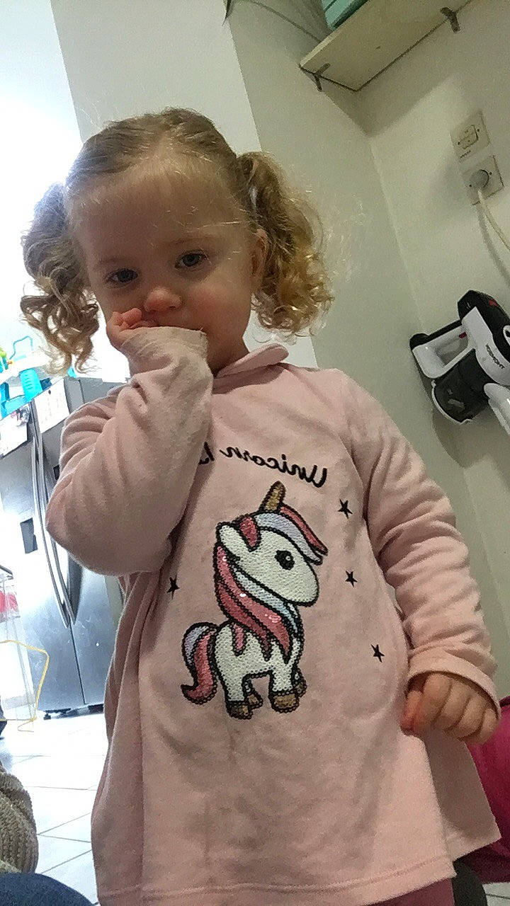 Camilya participe au concours pour gagner de l'argent avec cette photo : baby, baby_toddler_clothing, cheek, child, finger, font, fur, happy, hoodie, linens, pattern, person, room, skin, sleeve, standing, t_shirt, toddler, top, visual_arts