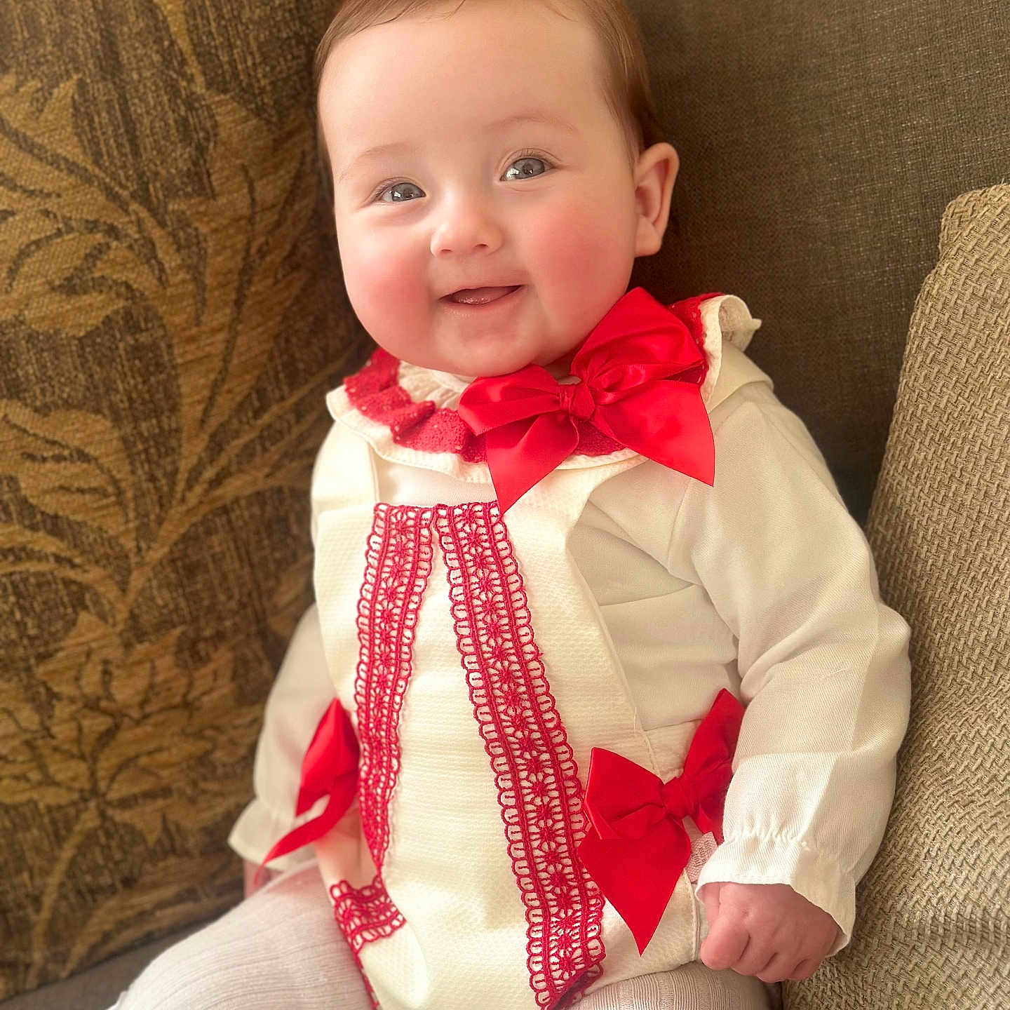 Lanesra joined the competition — help win amazing prizes! baby, child, clothing, couch, cozy, cushion, cute, face, furniture, happy, indoors, infant, lace, person, portrait, red_bow, seated, smiling, soft_lighting, white_outfit