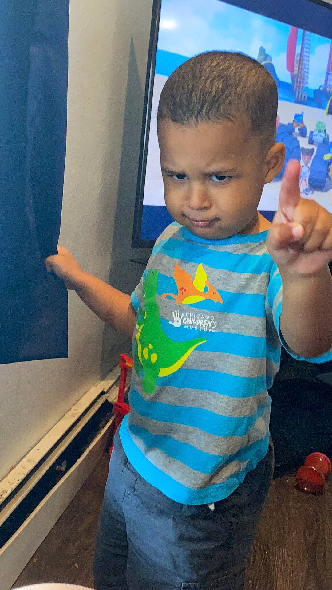 Aiden is registered to the contest to win money with this photo: arm, azure, blue, child, cool, elbow, electric_blue, finger, fun, gesture, hairstyle, hand, happy, leisure, person, shoulder, sleeve, standing, t_shirt, thumb