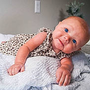 A'Mirah joined the competition — help win amazing prizes! baby, infant, blue_eyes, leopard_print, blanket, knitted, cute, face, skin, arm, hand, lying_down, indoors, expression, child, portrait, soft_texture, curious, head_tilt, cozy
