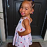 Jalani is registered to the contest to win money with this photo: toddler, child, smile, dress, hair_beads, door, doormat, footwear, pose, happy, cute, indoors, portrait, person, fashion, summer, young_child, standing, accessories, joyful