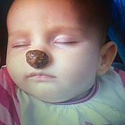 Flora participe au concours pour gagner de l'argent avec cette photo : baby, infant, sleeping, closed_eyes, face, nose, brown_snack, bib, clothing, cheek, mouth, ear, forehead, portrait, closeup, indoor, soft_lighting, peaceful, balancing, cute