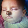 baby, infant, sleeping, closed_eyes, face, nose, brown_snack, bib, clothing, cheek, mouth, ear, forehead, portrait, closeup, indoor, soft_lighting, peaceful, balancing, cute