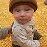 Jettson joined the competition — help win amazing prizes! toddler, child, beanie, corn_kernels, sitting, curious, indoor, play_area, hat, casual_clothing, long_sleeves, pants, cute, portrait, face, blue_eyes, hand_drawn_heart, background_children, playtime, warm_colors