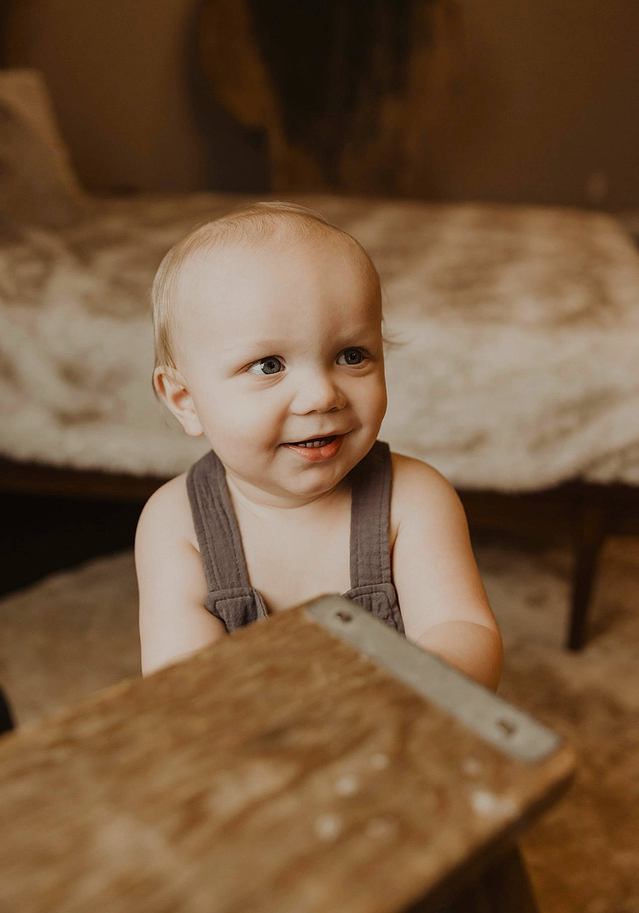 Lawson is registered to the contest to win money with this photo: baby, baby_toddler_clothing, cheek, child, facial_expression, finger, flash_photography, flooring, fun, happy, hardwood, joy, people, person, sitting, skin, smile, table, toddler, varnish
