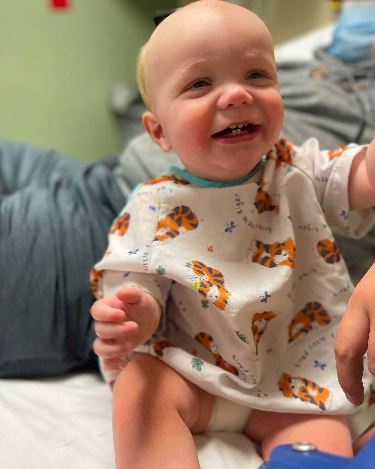 Lawson is registered to the contest to win money with this photo: baby, baby_toddler_clothing, cheek, child, comfort, event, face, facial_expression, fun, gesture, happy, head, mouth, orange, person, sitting, skin, sleeve, smile, thumb