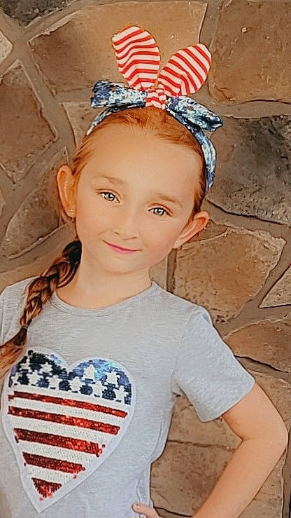 Callie is registered to the contest to win money with this photo: blue, chin, cool, eye, forehead, fun, hairstyle, happy, head, headband, headgear, headpiece, joy, neck, organ, person, pink, red, skin, sleeve