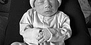 Harlow joined the competition — help win amazing prizes! baby, newborn, sleeping, hat, pom_poms, onesie, hands, face, person, lap, black_and_white, cozy, cute, indoor, bottle, resting, soft, infant, clothing, peaceful