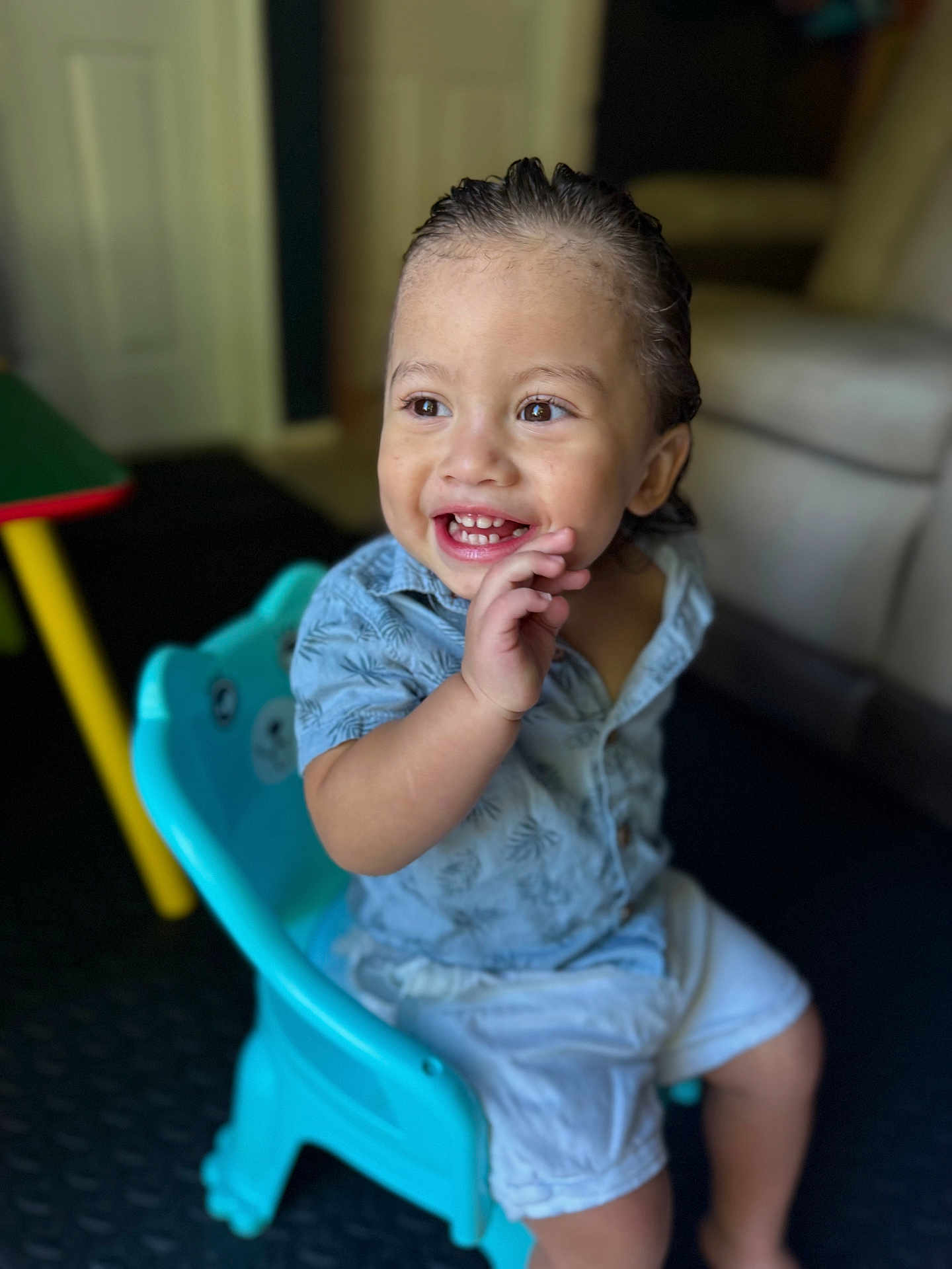 Jonathan is registered to the contest to win money with this photo: toddler, child, smiling, happy, indoor, chair, blue_chair, clothing, shorts, shirt, person, face, hair, hand, playful, cute, seated, home, furniture, expression