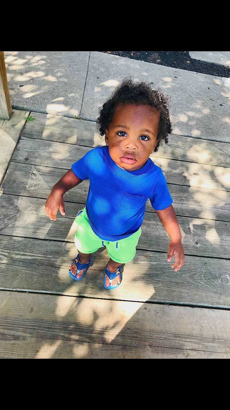 Pierre is registered to the contest to win money with this photo: baby, blue, child, fun, happy, people, person, play, smile, standing, t_shirt, toddler, vacation, water