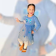 Myla is registered to the contest to win money with this photo: child, girl, blue_dress, smile, peace_sign, posing, long_sleeves, sparkles, bows, white_tights, brown_boots, fur_trim, happy, portrait, studio_lighting, isolated, fashion, cute, playful, background_blur