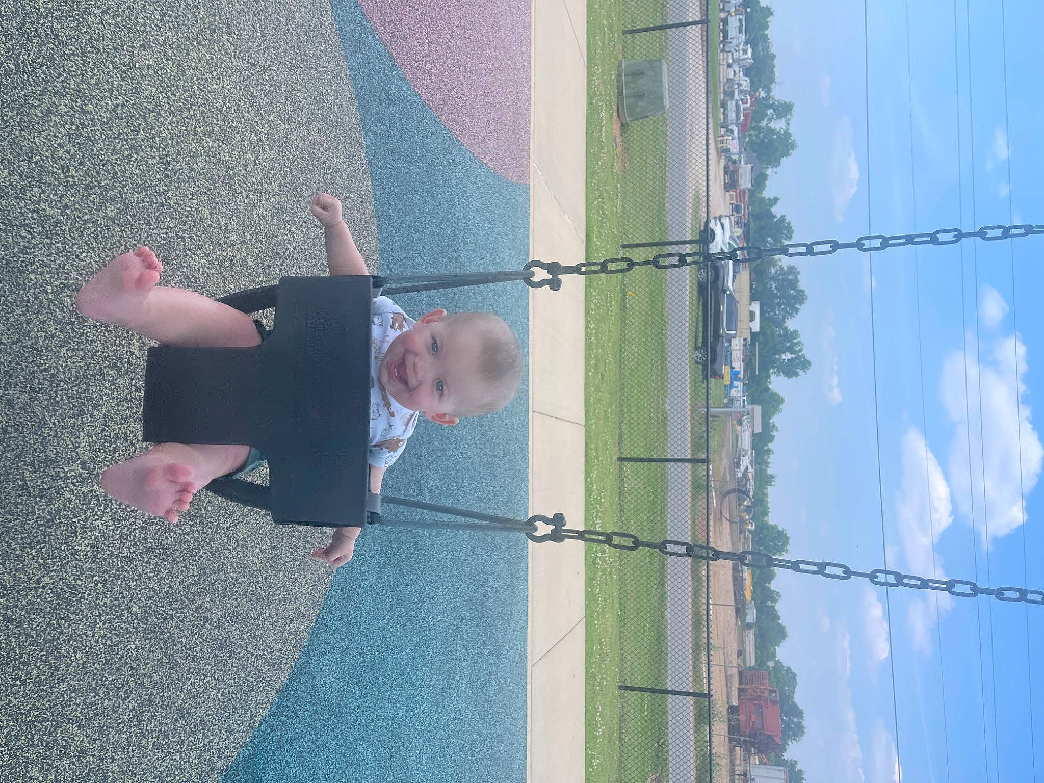 Joseph is registered to the contest to win money with this photo: asphalt, blue, cloud, electric_blue, electricity, fun, joy, overhead_power_line, person, plant, pole, public_utility, reflection, road_surface, shadow, sky, tar, toddler, tree, wall