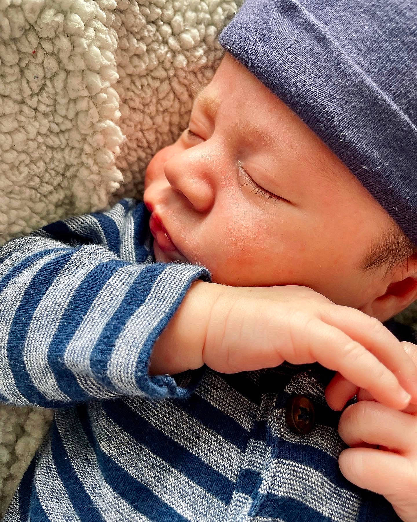 Allen is registered to the contest to win money with this photo: arm, baby_sleeping, cap, comfort, cool, eye, eyelash, face, finger, forehead, gesture, happy, head, headwear, lip, nail, nose, person, skin, textile