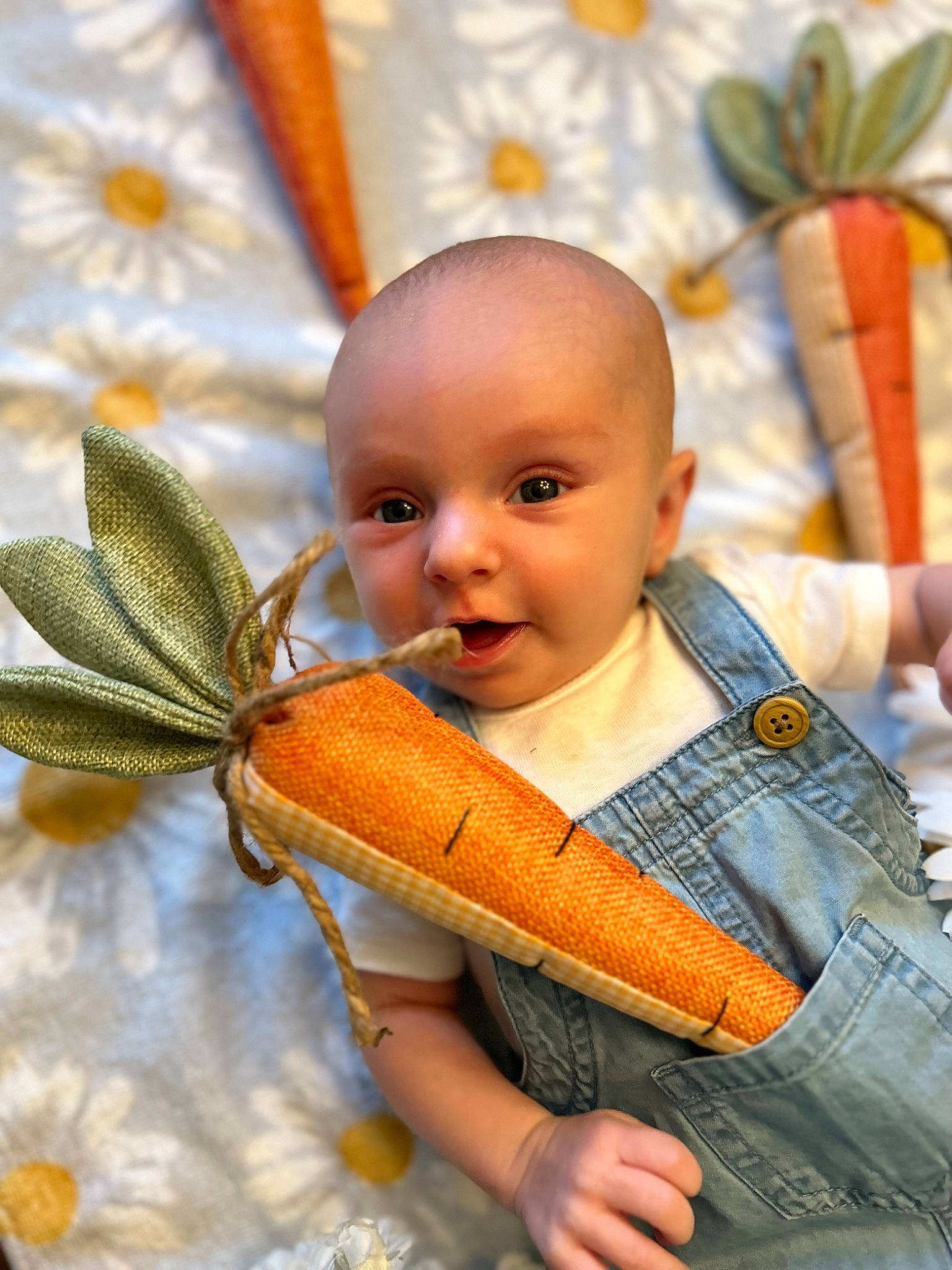 Fiona is registered to the contest to win money with this photo: baby, baby_products, baby_toddler_clothing, child, eye, facial_expression, fashion_accessory, fun, hairstyle, happy, head, jewellery, orange, pattern, peach, person, portrait_photography, sitting, skin, toddler