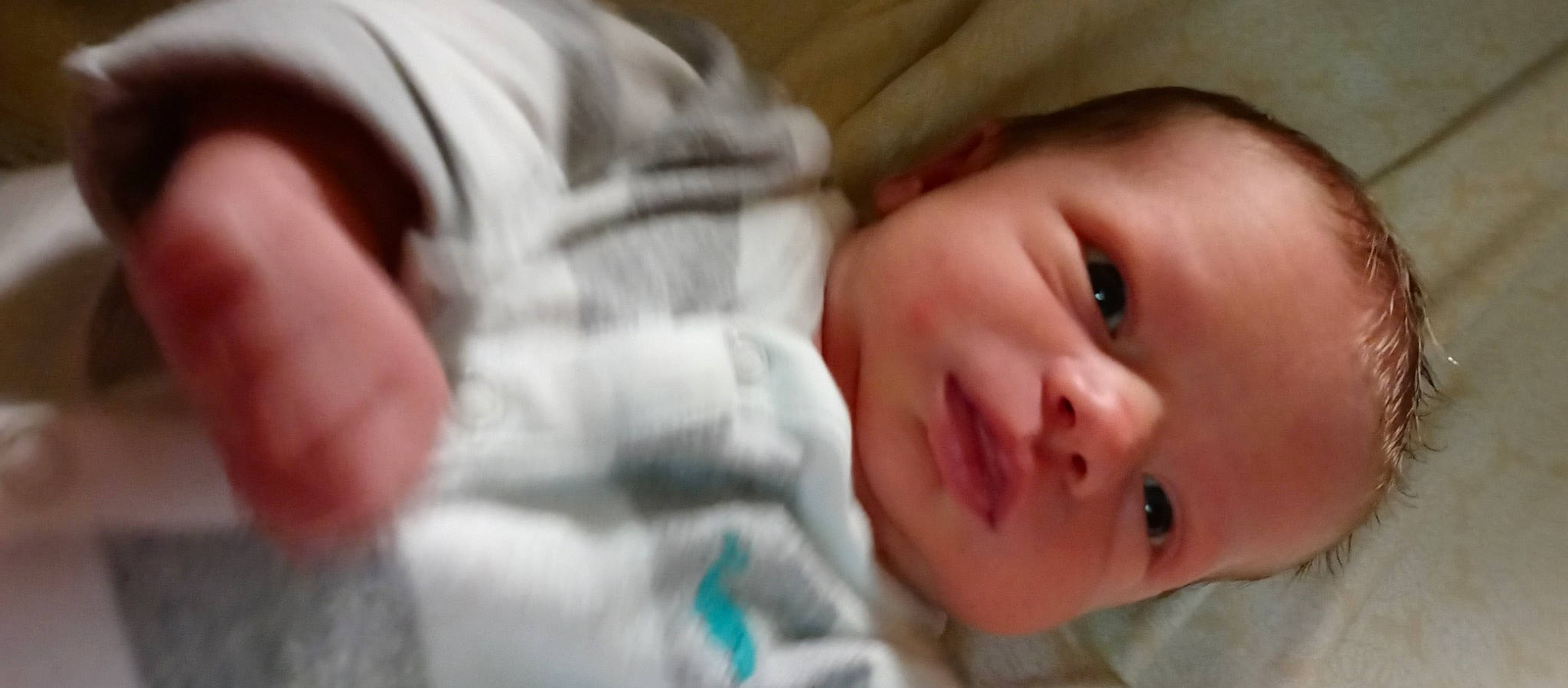 Jameson is registered to the contest to win money with this photo: baby, baby_toddler_clothing, bedtime, cheek, child, comfort, ear, eye, eyelash, finger, gesture, hand, human, iris, mammal, nose, person, skin, smile, thumb