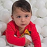 toddler, child, ball_pit, white_balls, red_shirt, indoor, play, cute, curious, young_child, person, portrait, fun, entertainment, leisure, kid, face, hair, eyes, hand