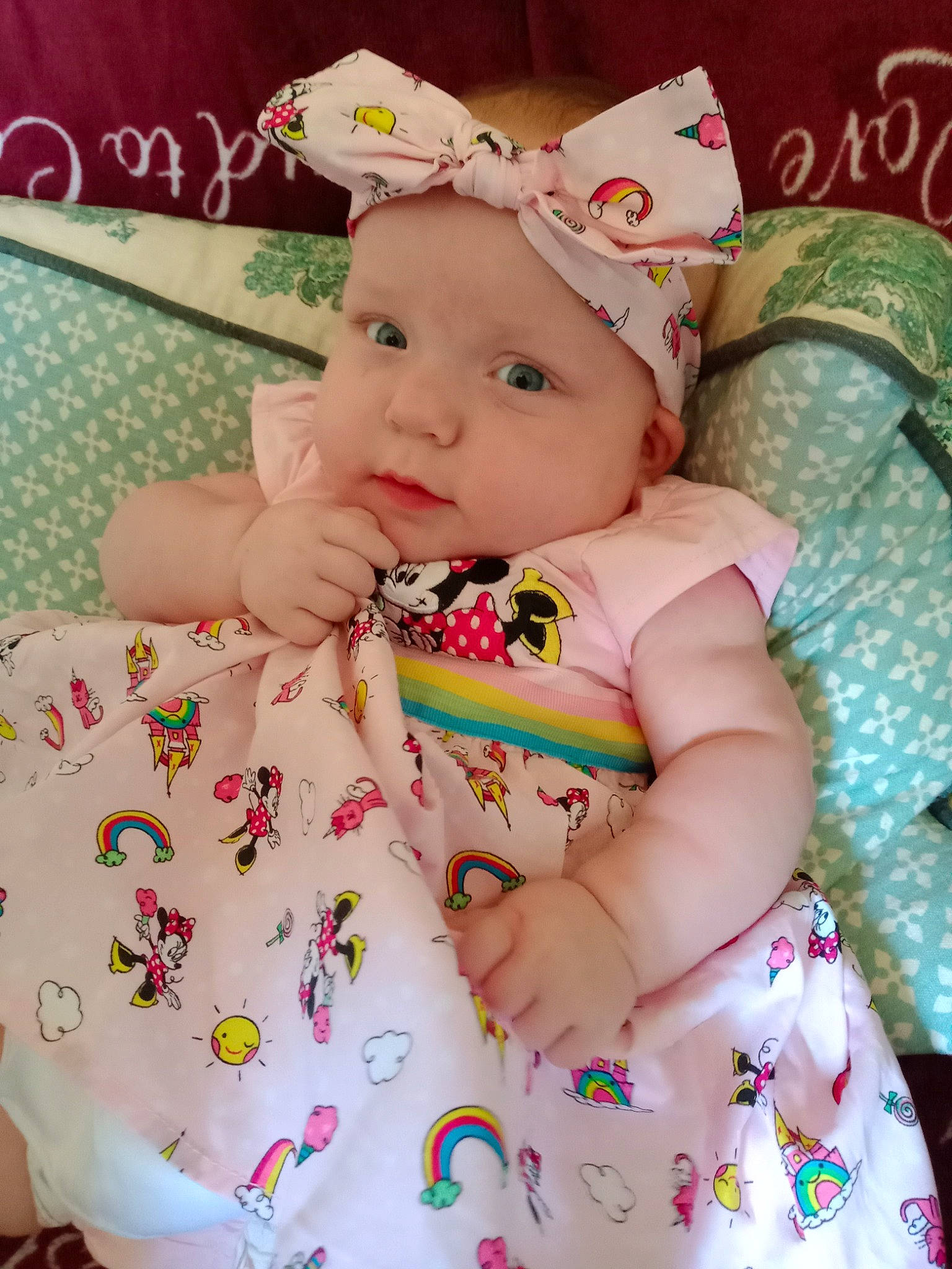 Isabella is registered to the contest to win money with this photo: baby, baby_toddler_clothing, cheek, child, dress, eyelash, fashion_accessory, happy, headband, headgear, headpiece, headwear, jewellery, pattern, peach, person, pink, skin, sleeve, sweetness