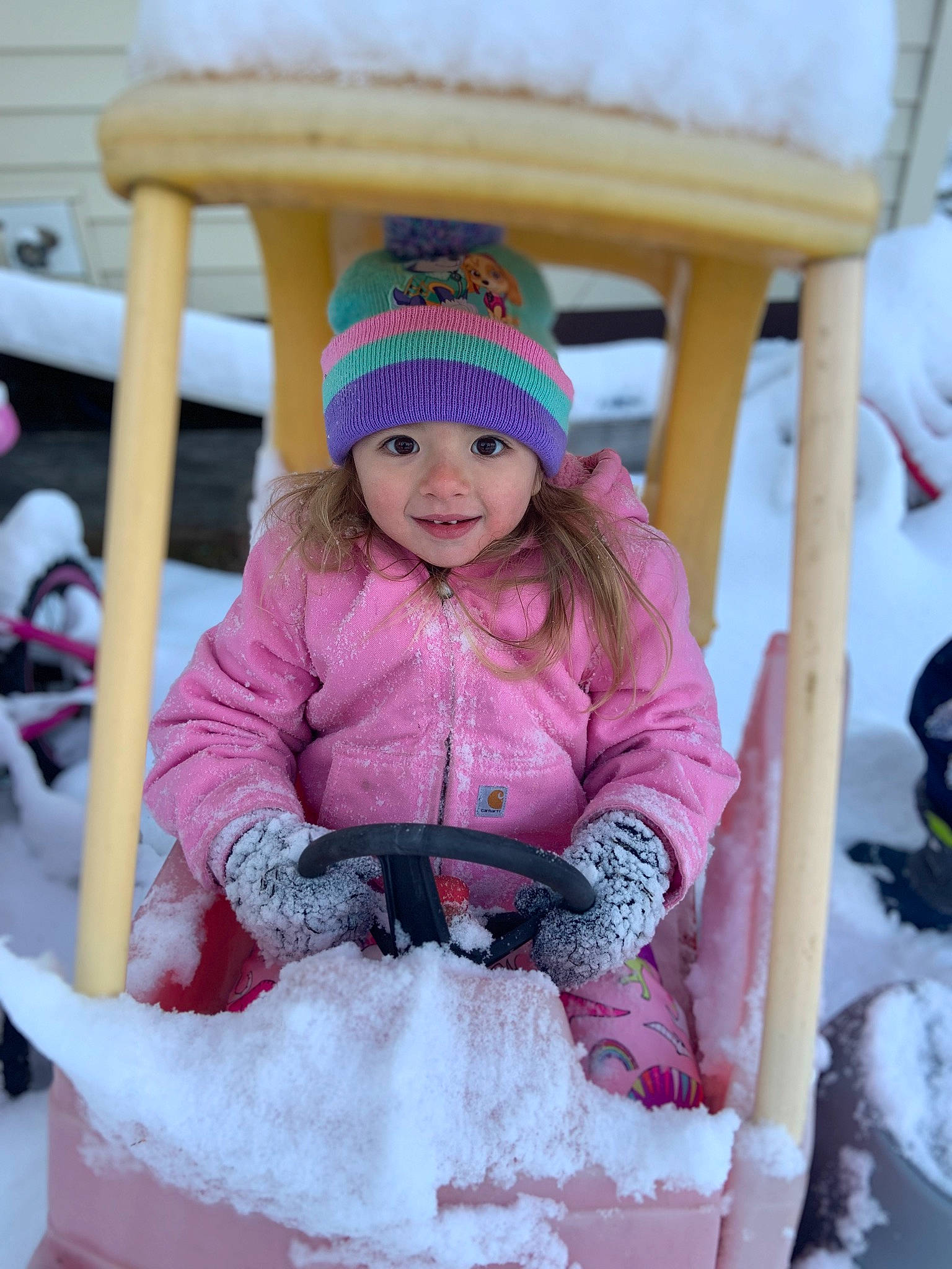 Luna is registered to the contest to win money with this photo: cap, child, event, freezing, fun, happy, headgear, headwear, jacket, joy, knit_cap, leisure, magenta, person, recreation, sitting, smile, snow, toddler, vacation