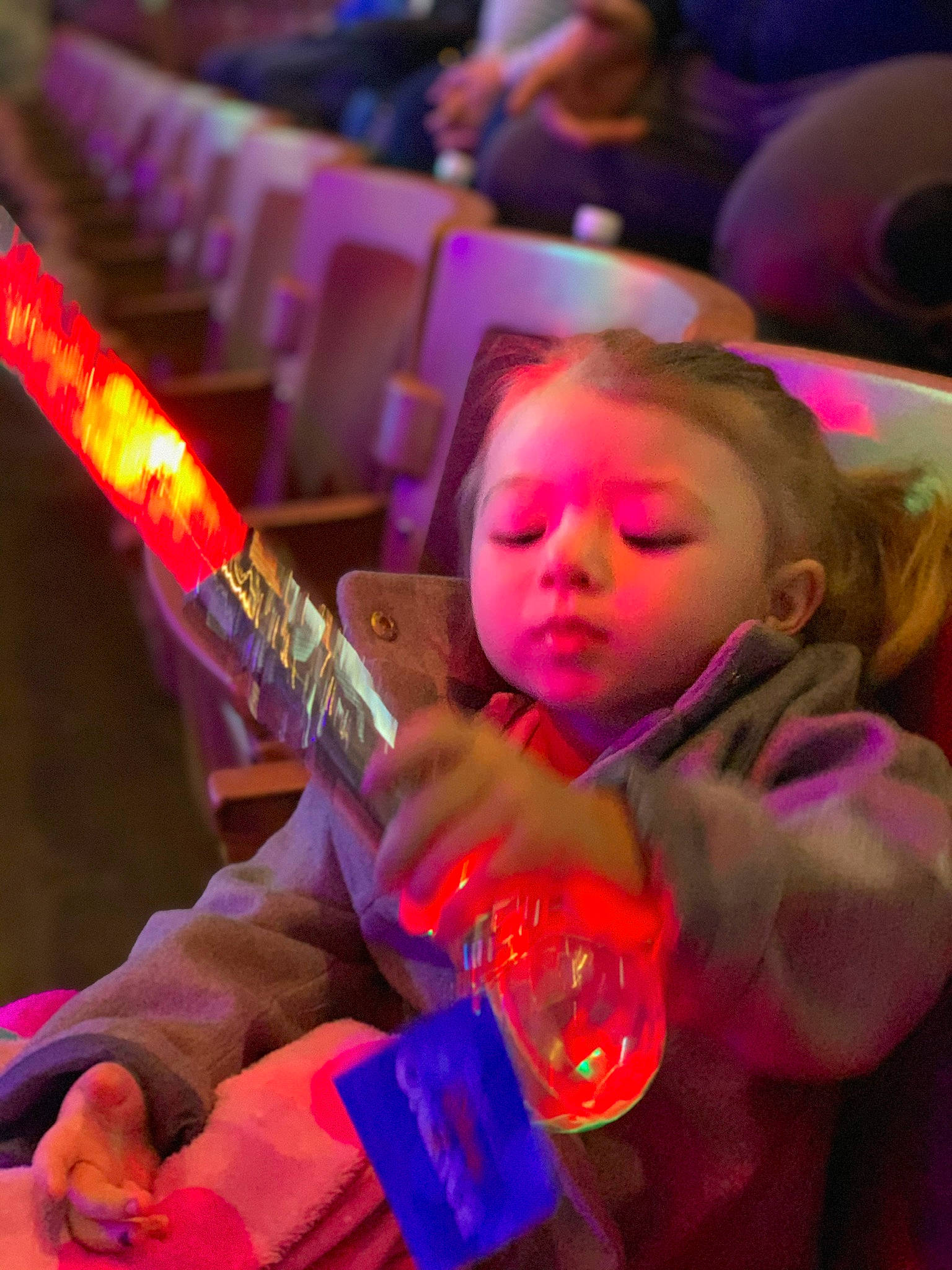 Luna is registered to the contest to win money with this photo: artist, child, entertainment, event, fun, guitar, guitar_accessory, light, magenta, music, musical_instrument, musical_instrument_accessory, musician, performance, performing_arts, person, plucked_string_instruments, purple, red, string_instrument