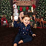 toddler, child, smiling, holiday, christmas, snowman, reindeer, tree, toy, pajamas, indoor, decorations, festive, candle, gift, plush, floor, playful, cute, holiday_season