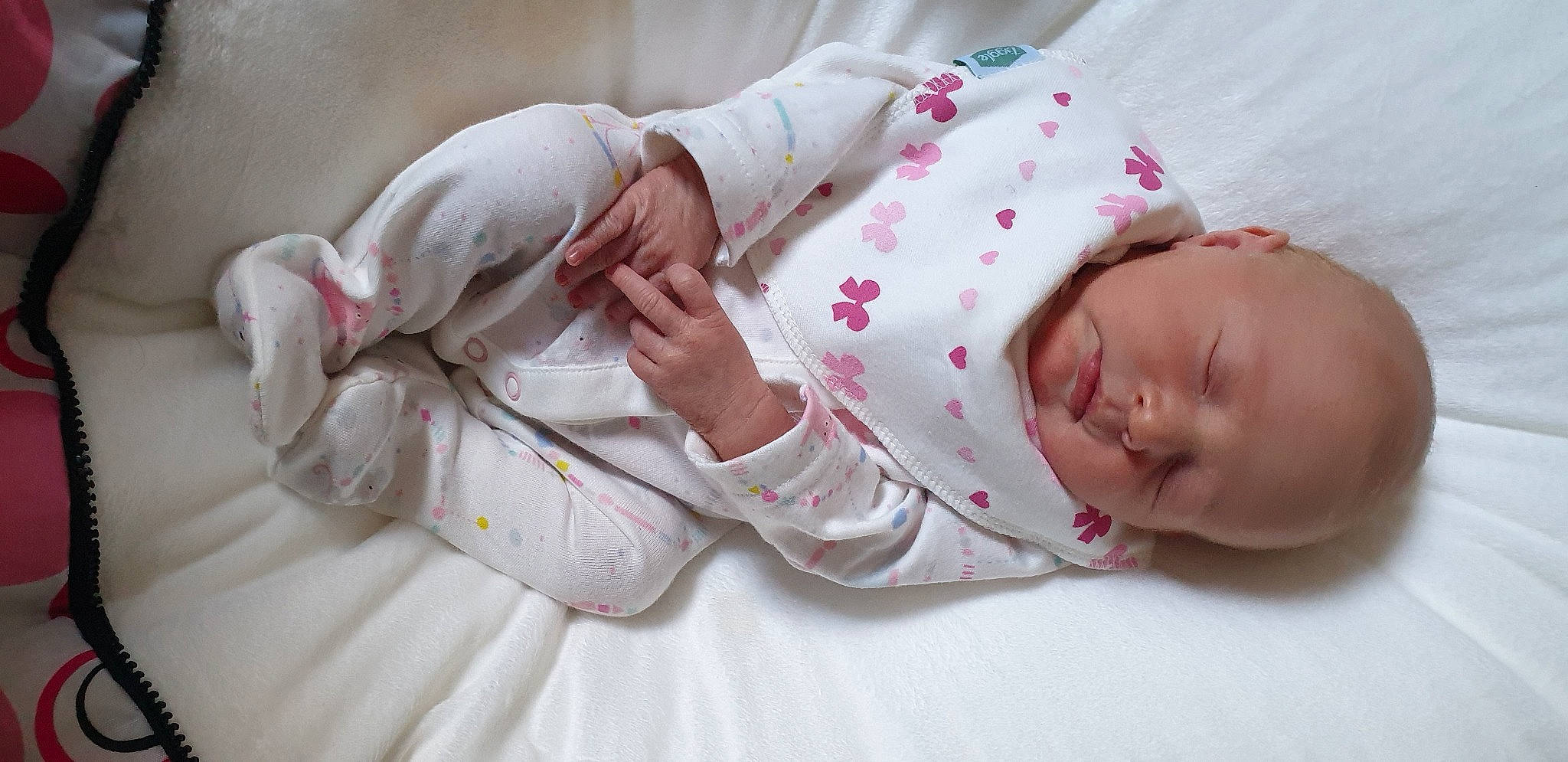 Priya is registered to the contest to win money with this photo: arm, baby, baby_products, baby_sleeping, baby_toddler_clothing, bedding, bedtime, cheek, child, comfort, finger, gesture, hand, headgear, linens, lip, person, pink, skin, sleeve