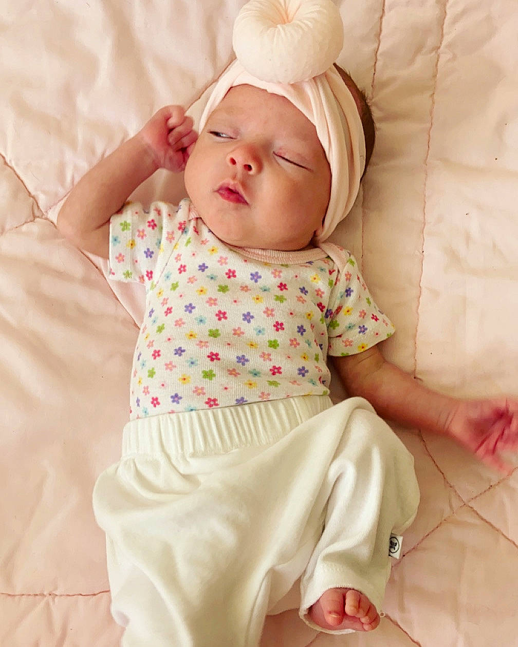 Amelia is registered to the contest to win money with this photo: baby, baby_products, baby_sleeping, baby_toddler_clothing, cap, cheek, child, comfort, face, fashion_accessory, headwear, linens, pattern, peach, person, pink, skin, sleeve, t_shirt, textile