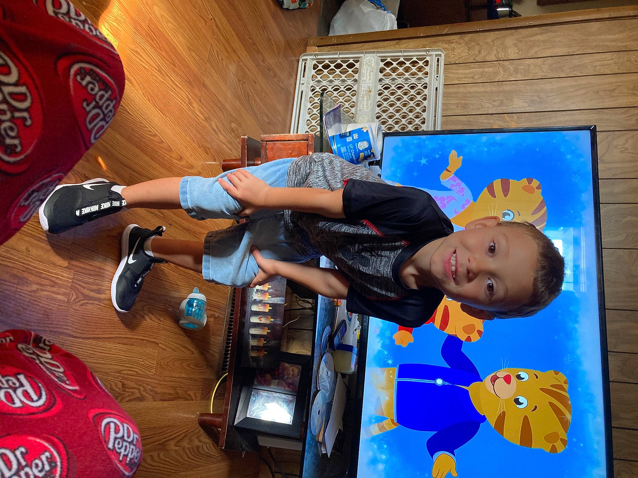 Braxton is registered to the contest to win money with this photo: beer, carbonated_soft_drinks, child, electric_blue, fun, joy, leisure, logo, luggage_and_bags, musical_instrument, person, personal_protective_equipment, play, recreation, room, soft_drink, sports_equipment, t_shirt, toddler, toy