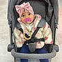 baby, stroller, pacifier, headband, pink_bow, jacket, fluffy_jacket, leopard_print_shoes, child, infant, seated, clothing, cute, indoor, floor_tiles, safety_harness, accessory, face, portrait, expression