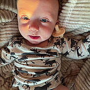 Kayson joined the competition — help win amazing prizes! baby, infant, pacifier, blanket, clothing, diaper, face, person, lying_down, cute, moose_pattern, soft, cozy, child, expression, skin, warm_light, indoors, comfort, newborn