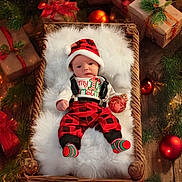 Kyler is registered to the contest to win money with this photo: baby, basket, christmas, holiday, ornament, gift, hat, plaid, red, green, white, wooden_floor, decorations, cozy, cute, festive, infant, socks, suspenders, fur_blanket