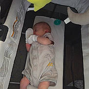 Riley joined the competition — help win amazing prizes! baby, newborn, sleeping, playpen, pajamas, striped_clothing, mittens, giraffe_print, toy, yellow_toy, infant, cozy, resting, crib, soft_toy, child, cute, peaceful, indoor, nap