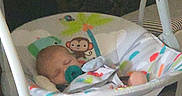 Riley is registered to the contest to win money with this photo: baby, swing, pacifier, sleeping, indoor, toy, monkey, colorful, blanket, infant, child, comfort, furniture, pattern, floor, play, rest, cute, peaceful, home