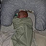 Riley is registered to the contest to win money with this photo: newborn, baby, sleeping, swaddle, pillow, blanket, infant, bed, rest, peaceful, soft, cozy, pattern, fabric, head, face, indoors, quiet, comfort, child
